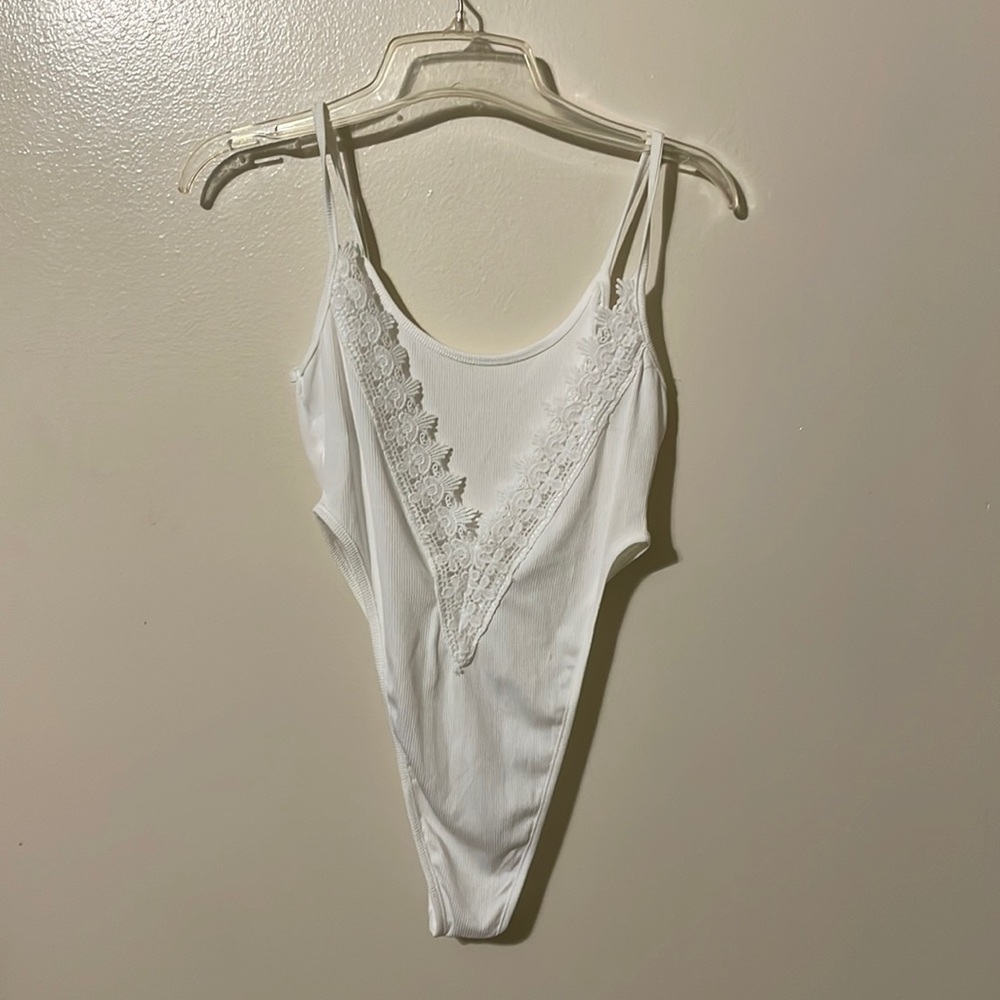 Brand new body suit with low back